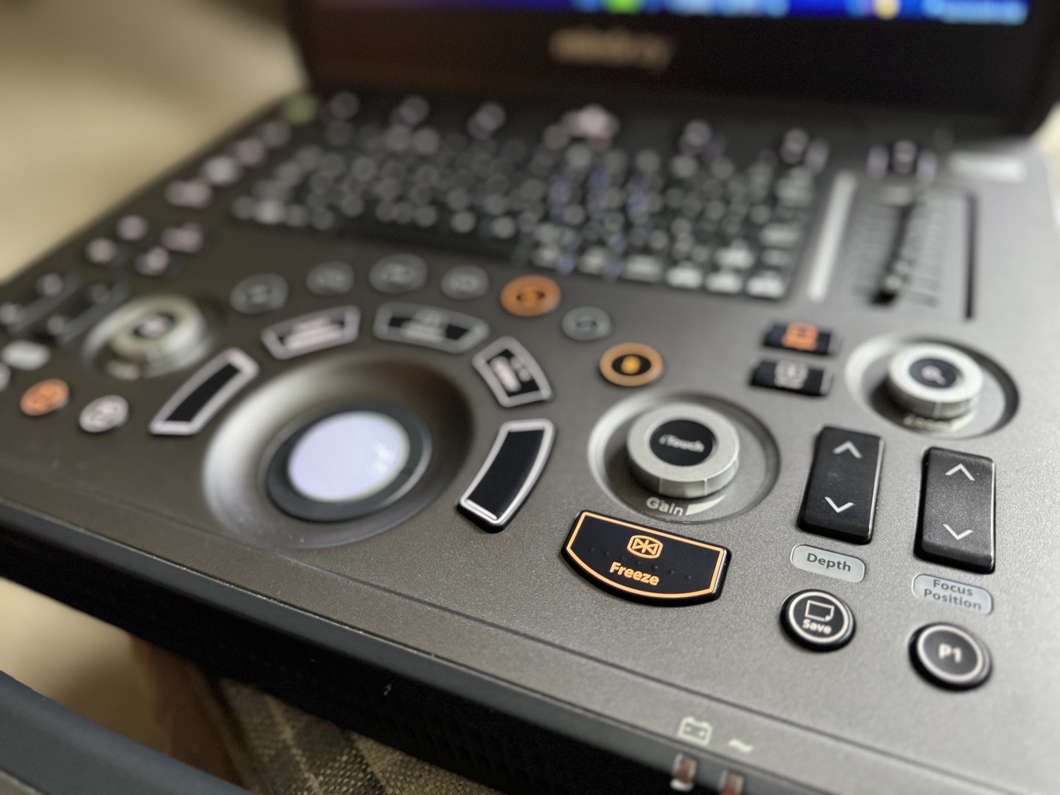 Close-up of a Mindray veterinary ultrasound console showing the trackball, gain dial and freeze control